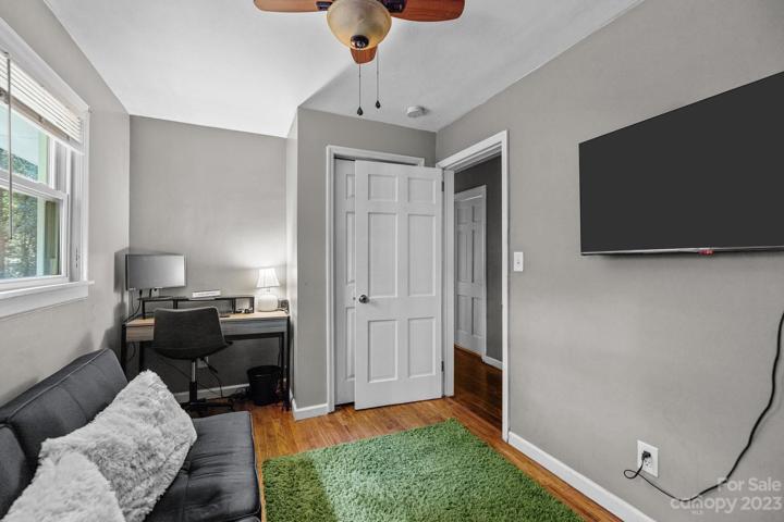 Third bedroom with optional desk nook. Features a modern ceiling fan and chalk wall.