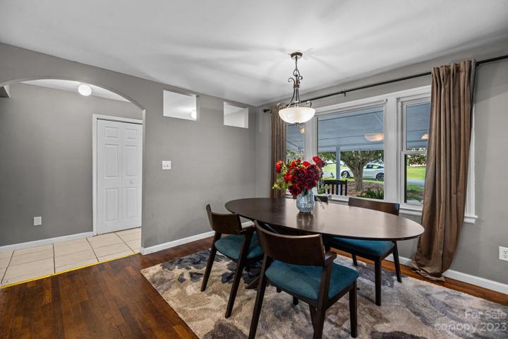 Create a smooth transition between the living room, kitchen, and flex space.  Note the use of vibrant area rugs in the open-concept living room allow for a cozier and more intimate feeling and maximize your line of sight.