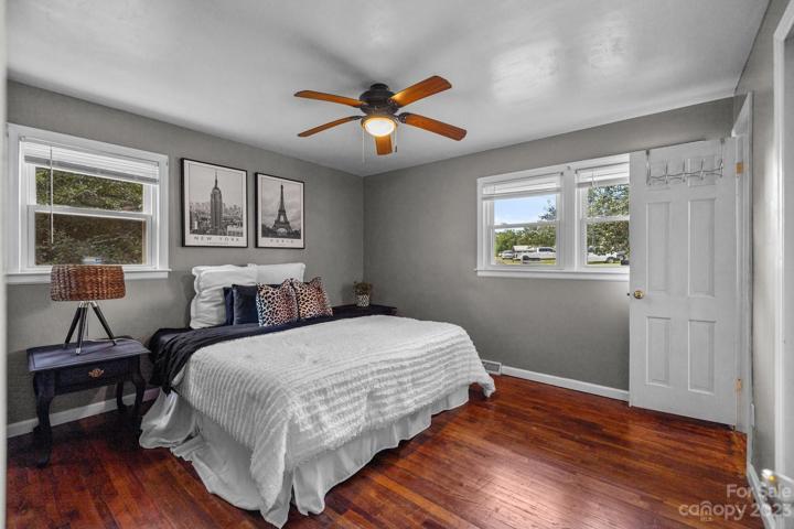 Entryway view of owners' suite. Showcasing hardwood  floors, high ceiling and with blinds open to display ample natural light.