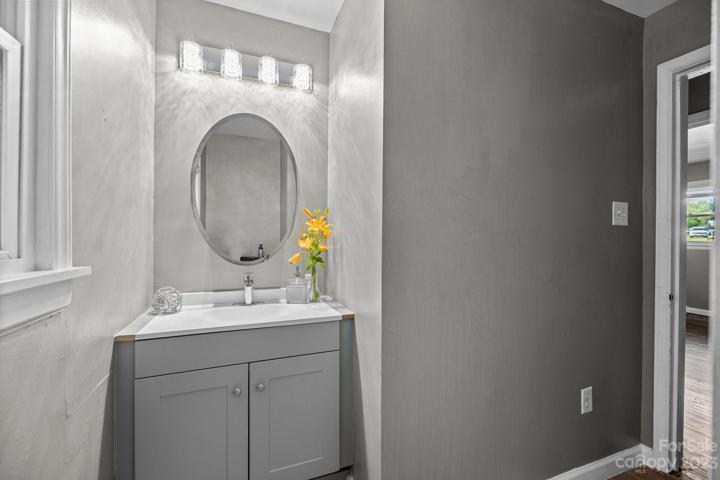 Second full bathroom. Enjoy the sleek lines of the single sink of the contemporary 36 in. vanity in gray with 2 doors. Space includes an oval mirror featuring gorgeous 4 trey lighting that mimics natural light clarity and spa serenity.