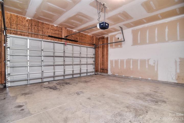 The driveway is generously sized, providing ample space for multiple vehicles and additional space in the garage.