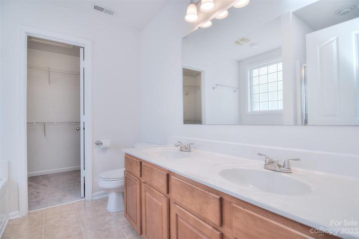 Dual vanity and tile floors accent this ensuite.