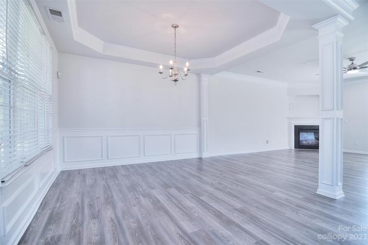 As you step into the house, the dining area immediately captures your attention with its graceful ambiance and inviting charm.