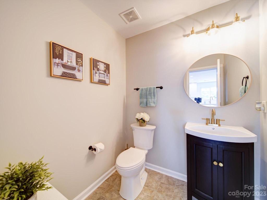 Powder room on main floor with updated lighting and fixtures!