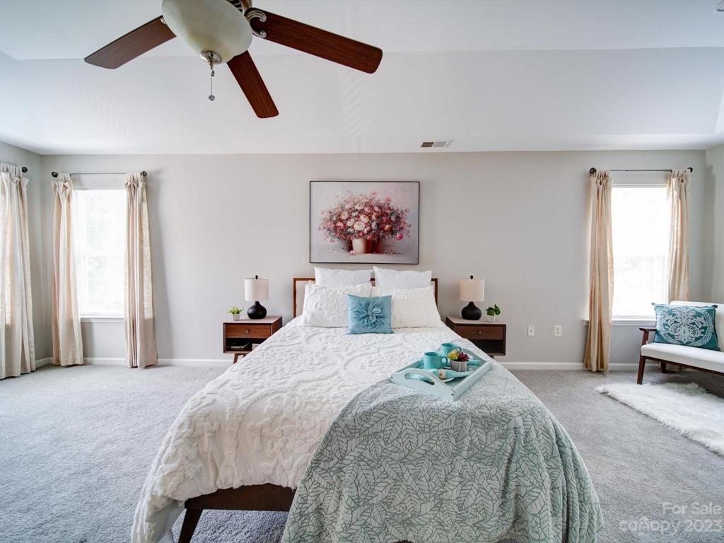 Primary suite boasts lots of windows for natural light