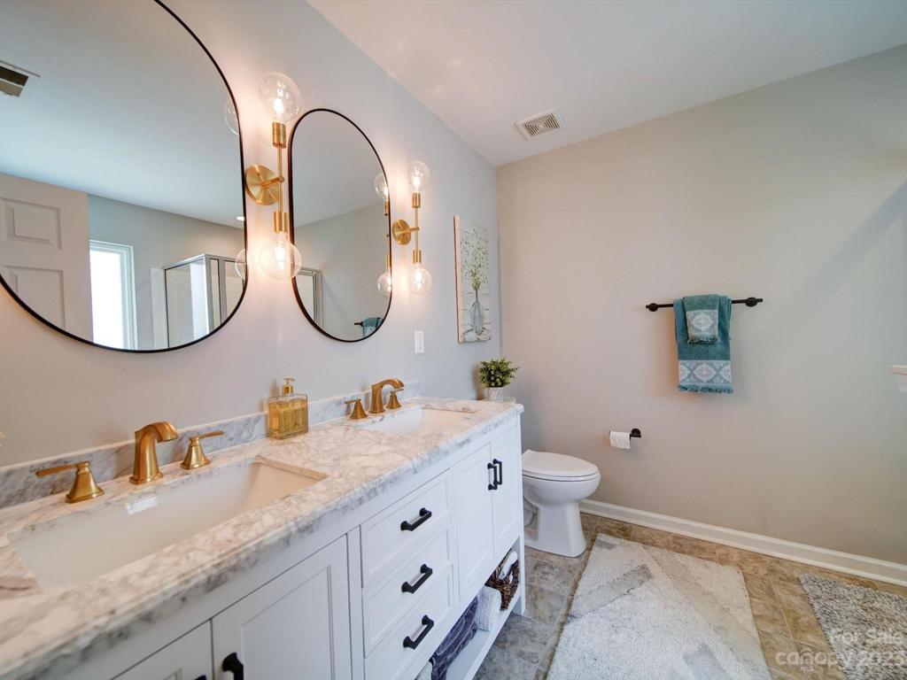 Updated, modern lighting, custom dual vanity and gorgeous mirrors!