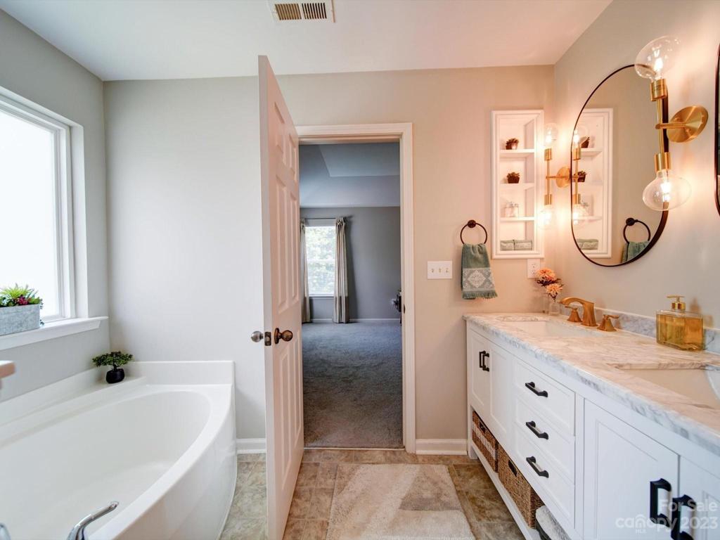 Primary bath includes soaker, garden tub & dual custom vanity!