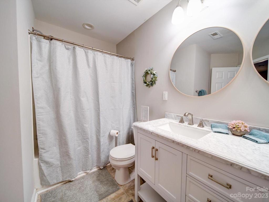 Custom dual vanity in common bath with new mirrors, hardware, lighting, and tops!