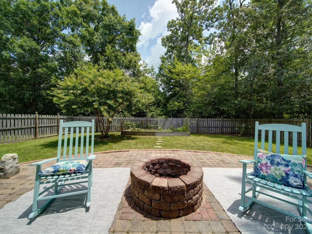 A custom fire pit is built into this extended paver patio for an entertainers dream space