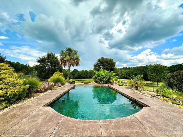 Gorgeous in-ground pool with Gunite pebble finish, Stamped concrete all around pool and sidewalks and beautiful landscaping in place.