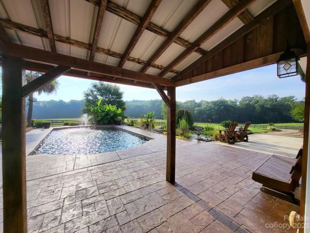 Porch view to the pool and Koi Pond.