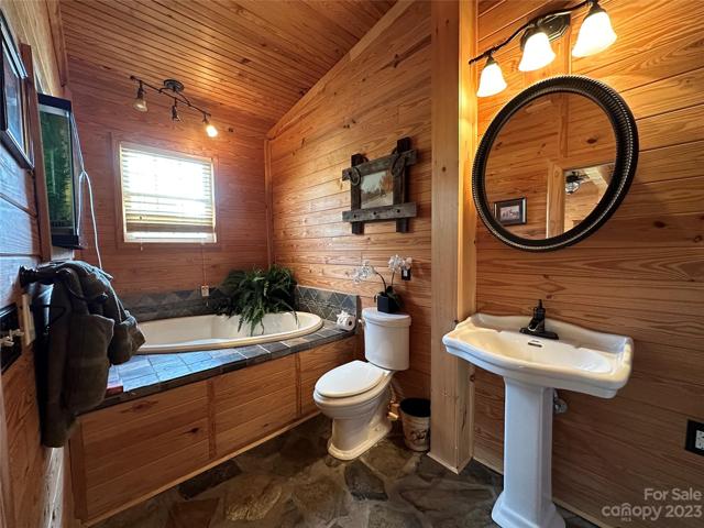 Warm and inviting primary bath with whirlpool tub and separate shower.
