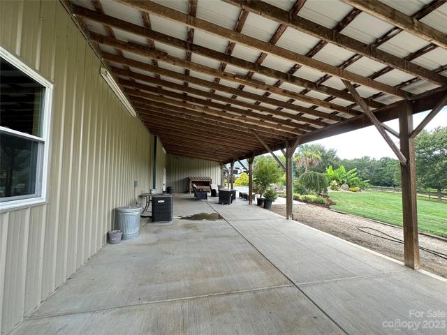Covered side porch with approximately 969 sq ft.  Perfect for your hot tub or outdoor kitchen, again so many possibilities.