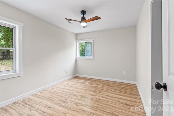 Welcome to your spacious primary bedroom suite with a modern ceiling fan!