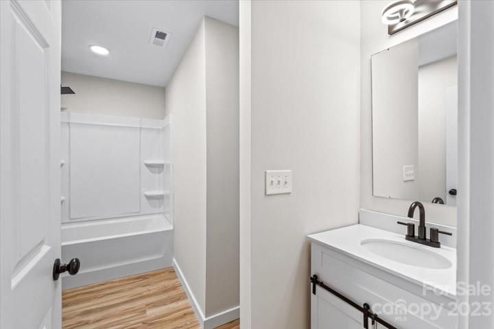 Easily accessible spare bathroom with a nook for extra storage!