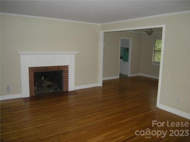 Large Living Room with gas log fireplace looking into Dining Room.