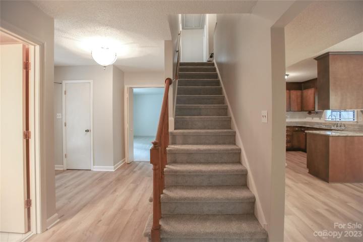 Entryway with stairs to 4 bedrooms and 2 full baths