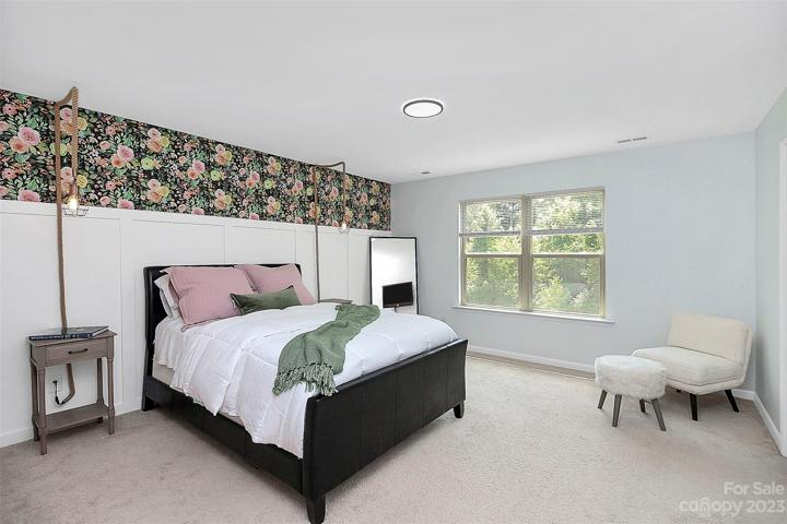 Large primary bedroom with board & batten accent wall.