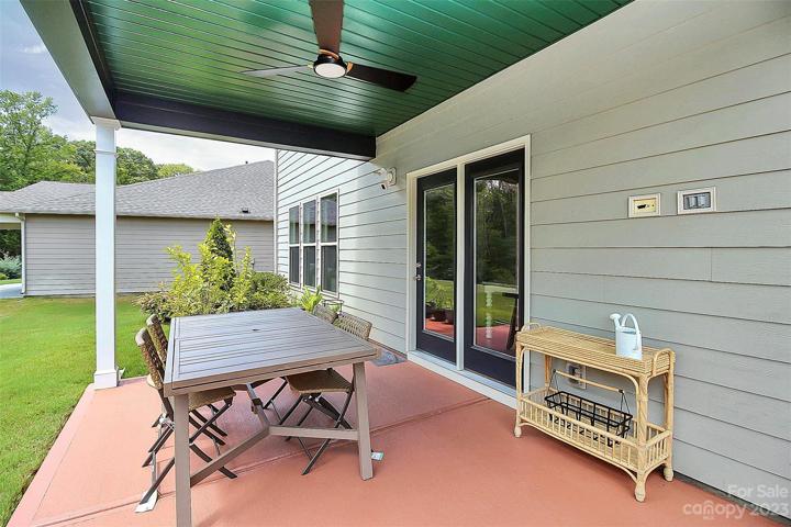 Covered patio with pull down screens and fan is perfect for dining al fresco!