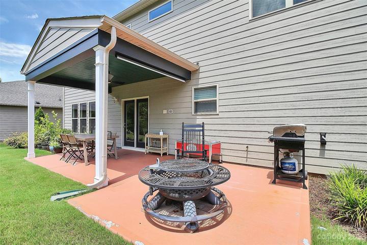 Covered patio extends on BOTH sides for grilling/seating/planting, etc.