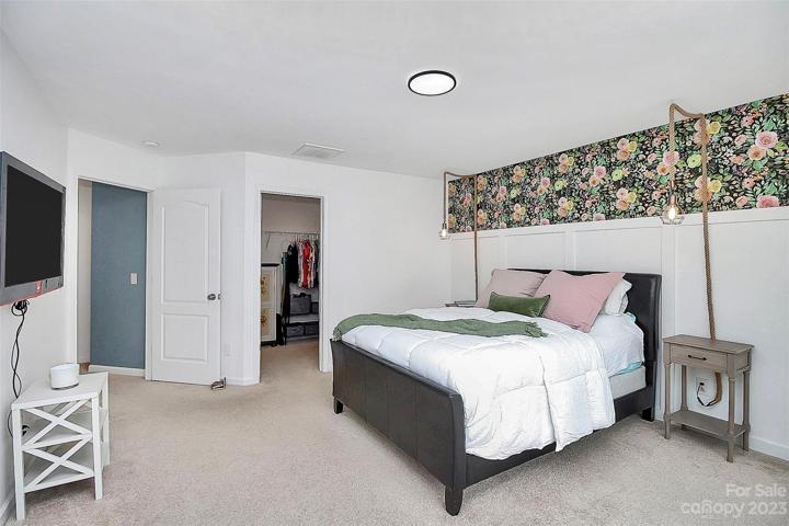 Located at end of hallway giving privacy to the primary bedroom.