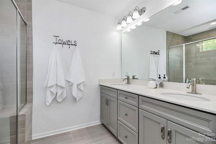 En suite primary bath  with dual vanity, water closet and linen closet!