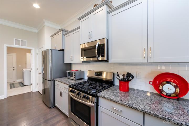 Kitchen featuring granite counter tops & stainless appliances