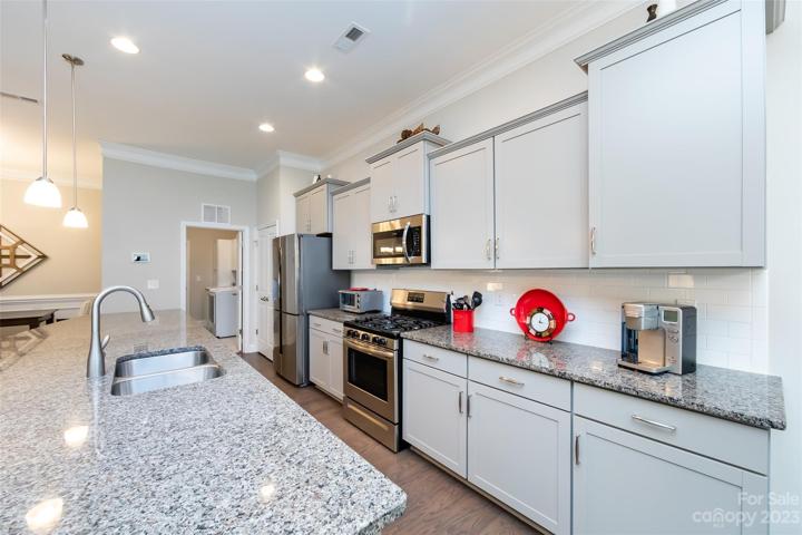 Kitchen featuring granite counter tops & stainless appliances