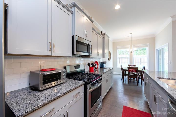 Kitchen featuring granite counter tops & stainless appliances