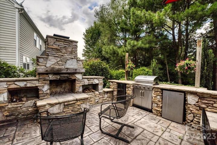 patio with built-in grill, fireplace and Refrigerator