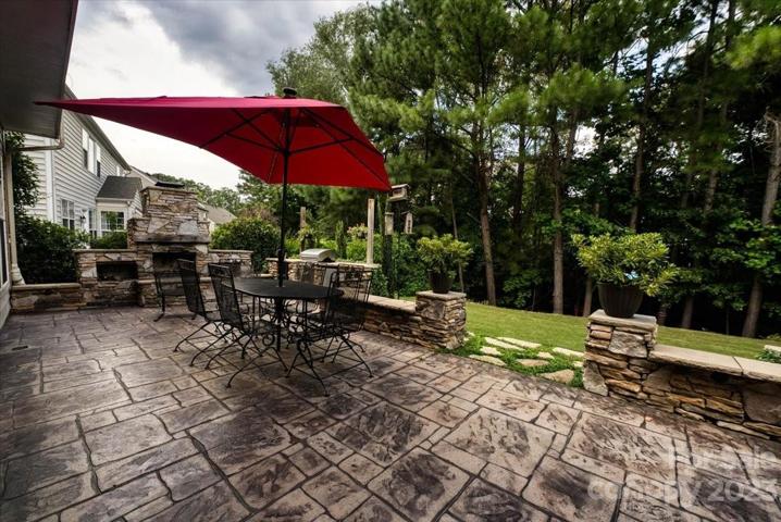 patio with built-in grill, fireplace and Refrigerator