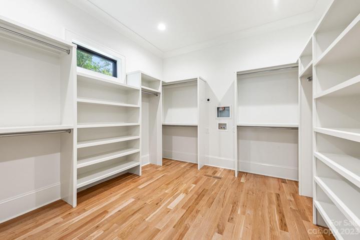 Large walk in primary closet with washer and dryer hookups