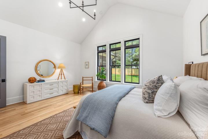 Main level primary bedroom with vaulted ceilings