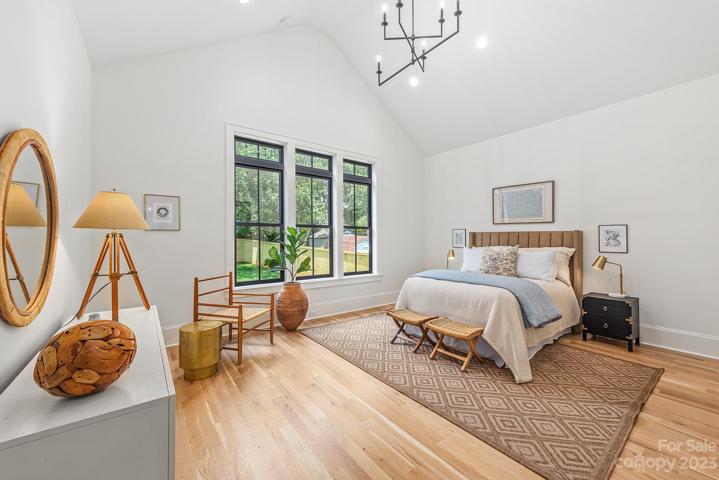 Primary bedroom with vaulted ceilings