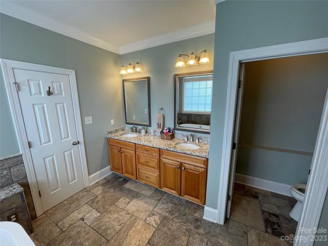 Upgraded master ensuite with travertine tile and double vanities with granite countertops!  And, your own water closet for privacy!