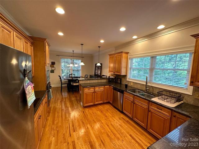 Huge kitchen newly painted with an abundance of cabinets and large windows for natural lighting.