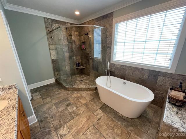 Close up of flooring, shower and tub.