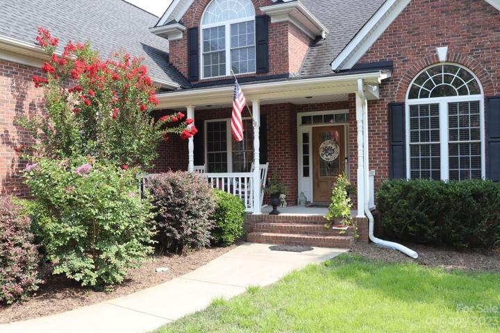 Full brick custom home with a welcoming rocking chair front porch!  Great place to sip sweet ice tea...