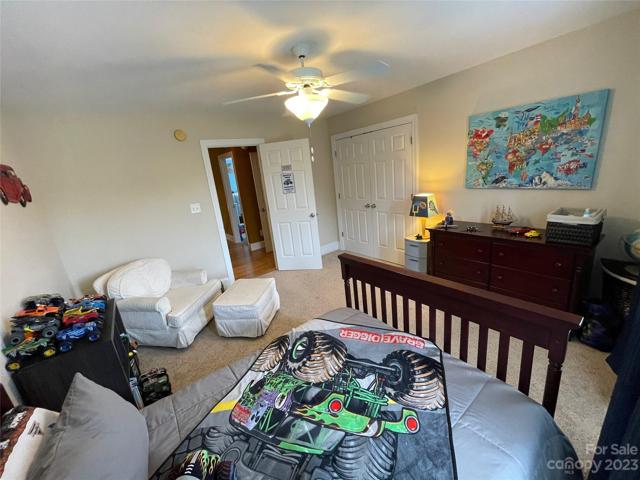 Bedroom 2 upstairs with double closets and ceiling fan.