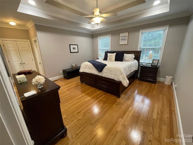 Fall in love with your primary bedroom on the main level.  What a beautiful space with double tray ceilings, ceiling fan and gleaming hardwoods.