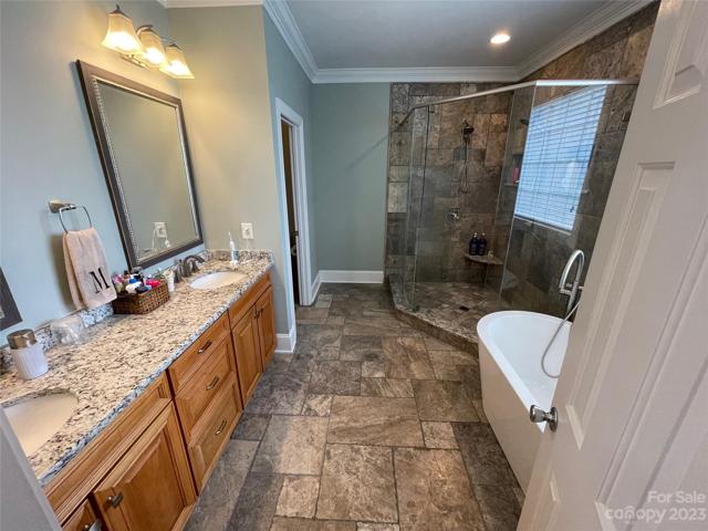Master ensuite showcasing the amazing travertine tile, double vanities, huge travertine shower with 2 shower heads and a new freestanding soaking tub!  EVERY WOMAN'S DREAM...