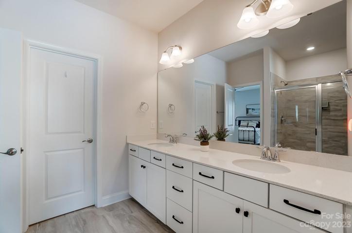 Primary Bath with dual vanity, quartz counter tops, and shower