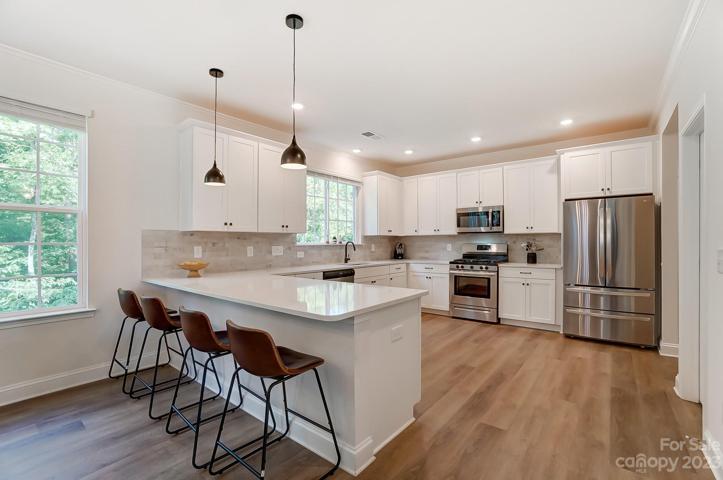 Kitchen w/quartz countertops and stainless steel appliances