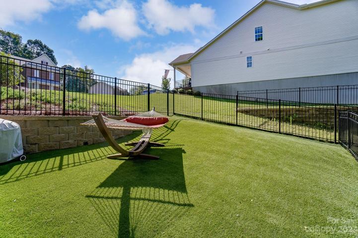 Fully fenced backyard space w/astro turf, great for kids or pets!