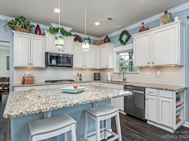 1st Flr - Kitchen, large island w/eat up bar, granite tops, Murano pendants, led panel lights
