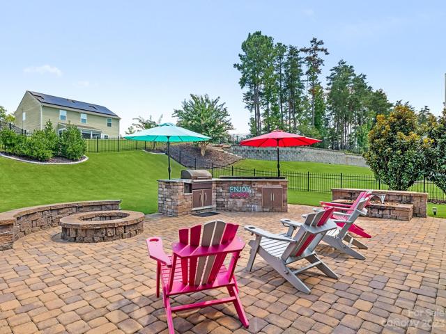 Extended Paver Area off screened porch - Wood burning Fire Pit w/sitting wall, Water feature, built in Tragaer Grill, Eat-up bar & mini fridge