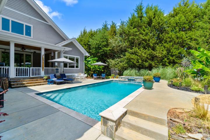 Pool has Pebble Tech lining. Travertine tile coping and natural stone accents. 111 Swayne Dr, Mooresville, NC 28117 - The Point