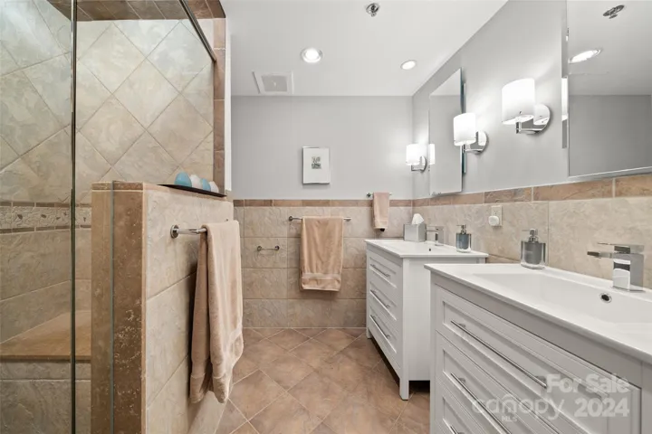 Dual vanities and large dual shower heads in the walk-in shower.