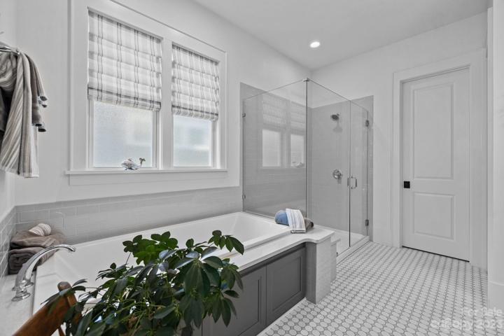 Soaking tub with large frameless glass shower
