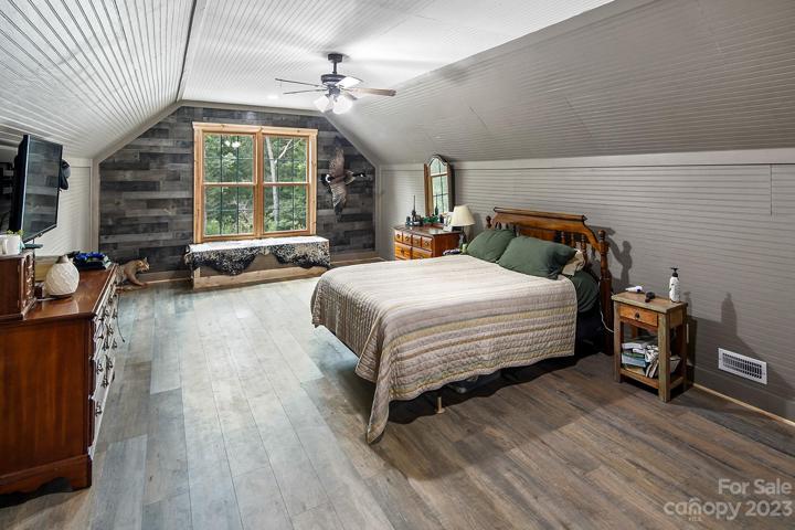 Generous primary bedroom with sitting area and walk-in closet